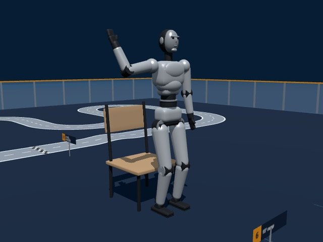 Unitree H2 full-size humanoid with a silver face, waving beside a chair