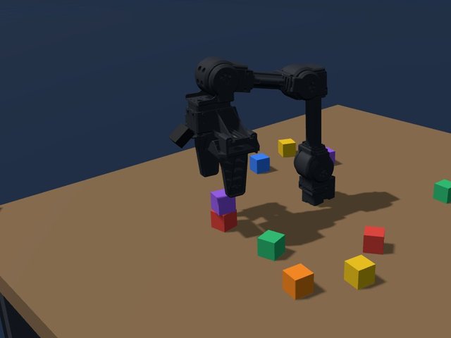 Small four-joint robot arm on a table stacking coloured blocks
